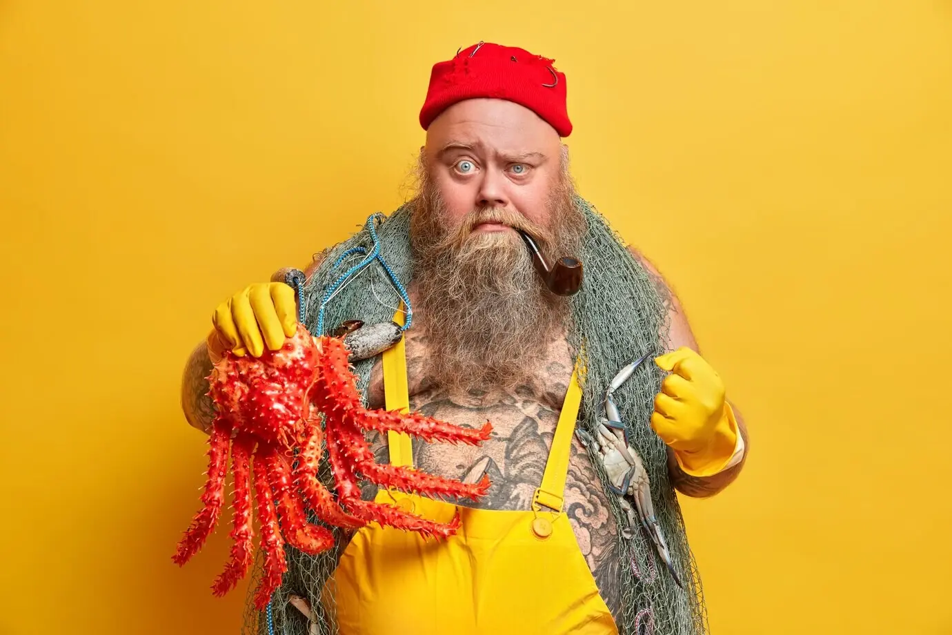 Adventure, hobby, and fishing theme. An angry fisherman with a stern, serious expression clenches his fist, displays an octopus caught during a marine voyage, frowns, and carries a fishnet.